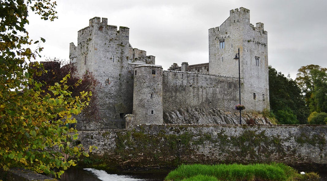 A view of the magnificent Cahir Castle from the banks of the River Suir - The Irish Place