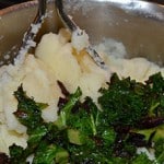 Kale and onion being mixed into the mashed potato.