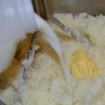 Milk and butter being mixed into the mashed potatoes.