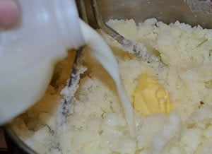 Milk and butter being mixed into the mashed potatoes - The Irish Place