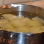 Potatoes peeled and chopped ready for boiling in salted water.