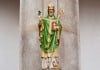 Patrick the Legend – The Story of St Patrick A statue of St Patrick holding a Shamrock in his right hand with some snakes at this feet - The Irish Place