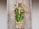 Patrick the Legend – The Story of St Patrick A statue of St Patrick holding a Shamrock in his right hand with some snakes at this feet - The Irish Place