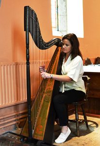 Mairead Murphy of the Irish Traditional Folk Group Dúnaill playing the Celtic Harp. - The Irish Place