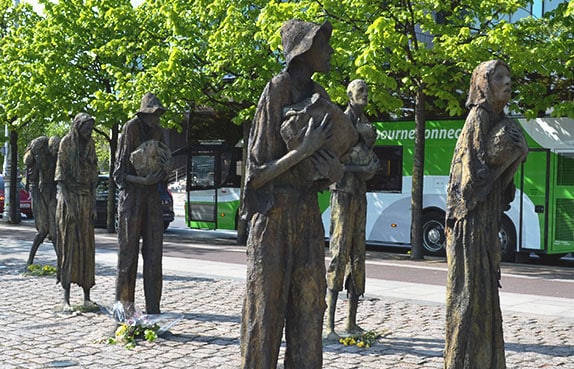 An emaciated weary group of individuals wending their way along the river towards passage to a better life in the U.S. or Canada. - The Irish Place