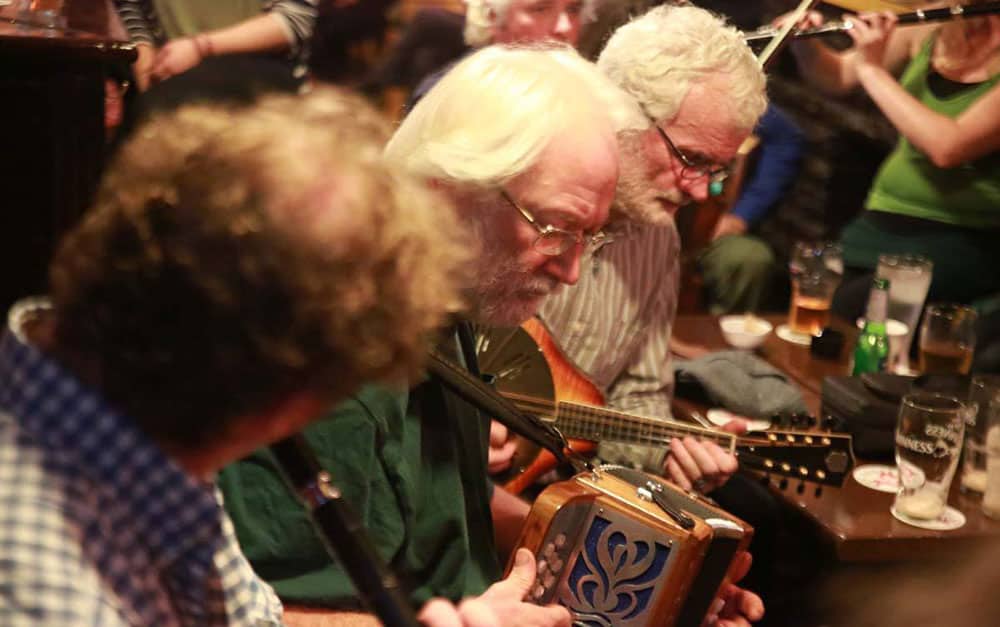 Musicians playing in an Irish Traditional Music session at Cooley's House, Ennistymon, Co. Clare. - The Irish Place