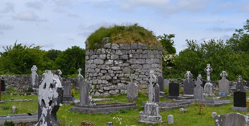 The stump of the round tower destroyed by Cromwell's forces at Kilnaboy Church - The Irish Place