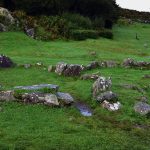 The joined stone huts with the Drombeg Stone Circle upper right.