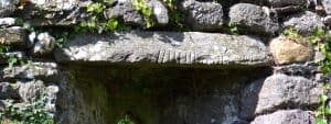 Ogham Stone used as lintel in lower window in Western Gable wall - The Irish Place