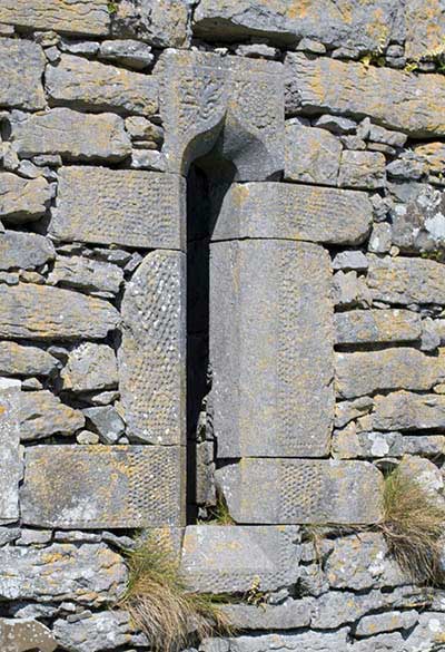 An Ogee Window with punched stonework and floral decoration on its head part.